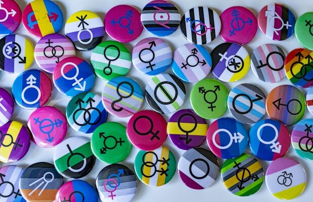 A bunch of different colored buttons on a white surface